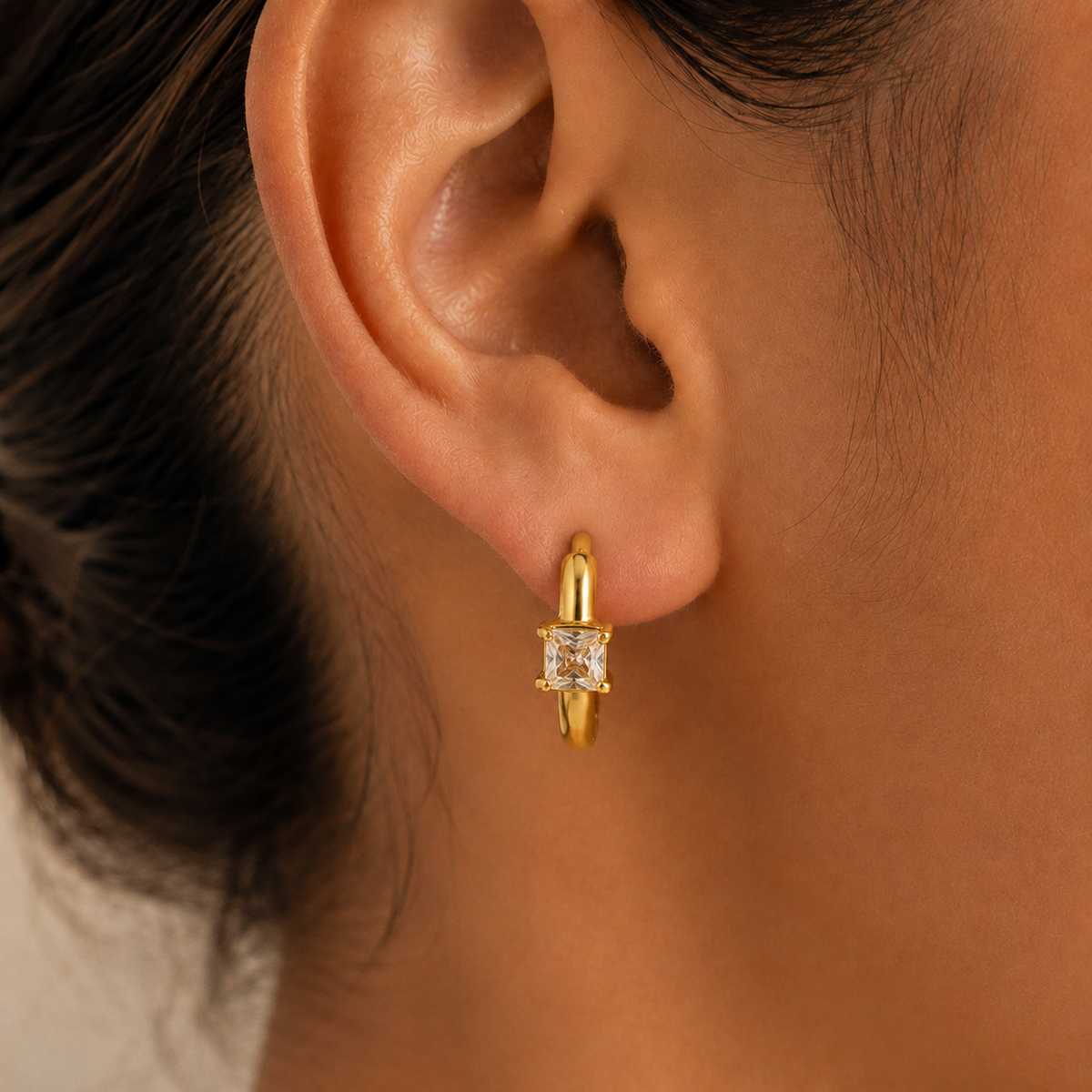Alessia Zircon Huggie Earrings worn by a model in a close-up