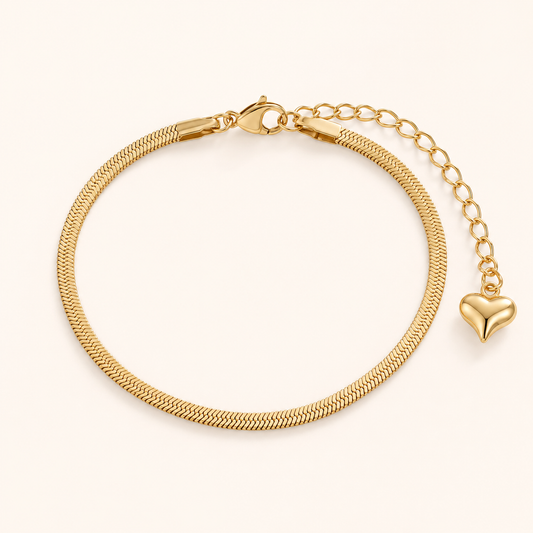 Aven Herringbone Bracelet — 18K gold PVD herringbone chain on a light ivory background