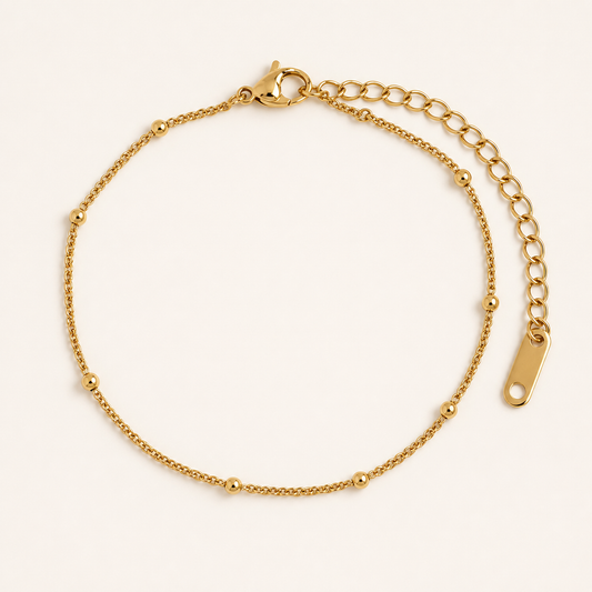 Inez Satellite Bracelet — 18K gold PVD satellite chain on a light ivory background