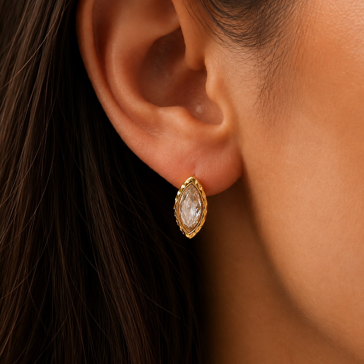 Sunlit Studs Earrings – gold marquise stud with a clear stone worn on the ear