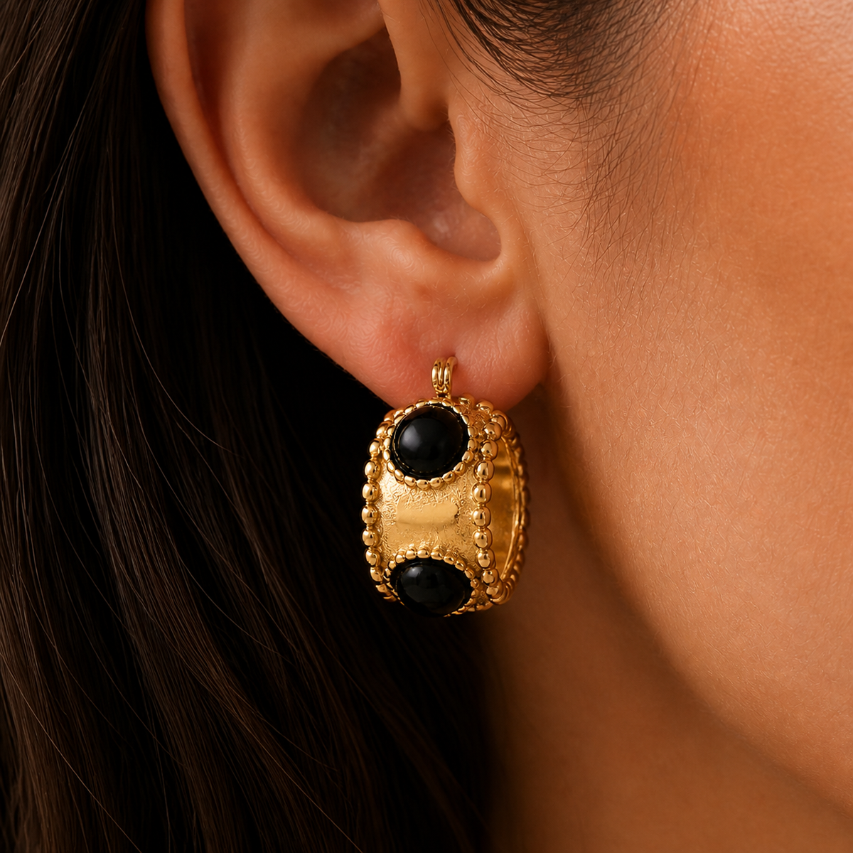 Oriane Hoop Earrings – wide gold hoop with black stones worn on an ear