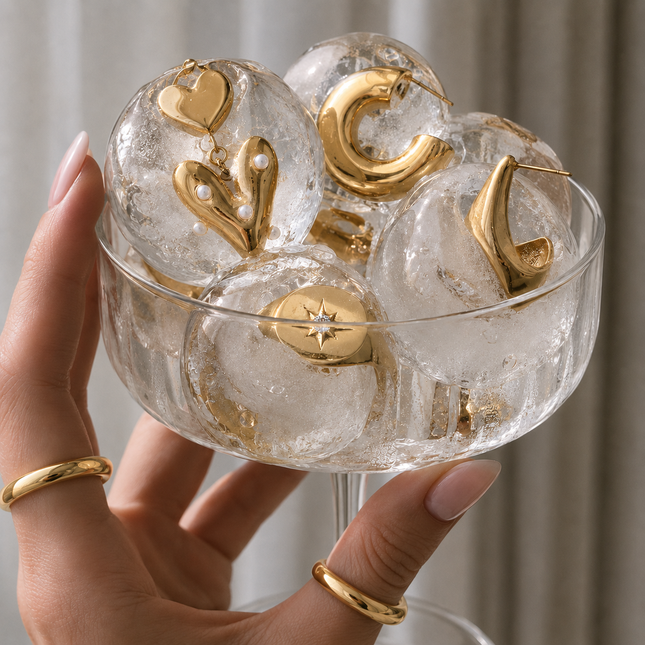 TAIA gold jewellery displayed in ice spheres in a glass
