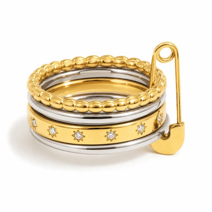 Atelier Ring – two-tone stacked bands with clear stones and safety pin detail