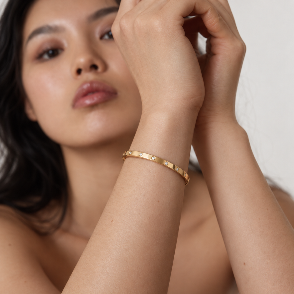 Delphine Zircon Dot Bangle in gold worn by a model — TAIA Jewellery