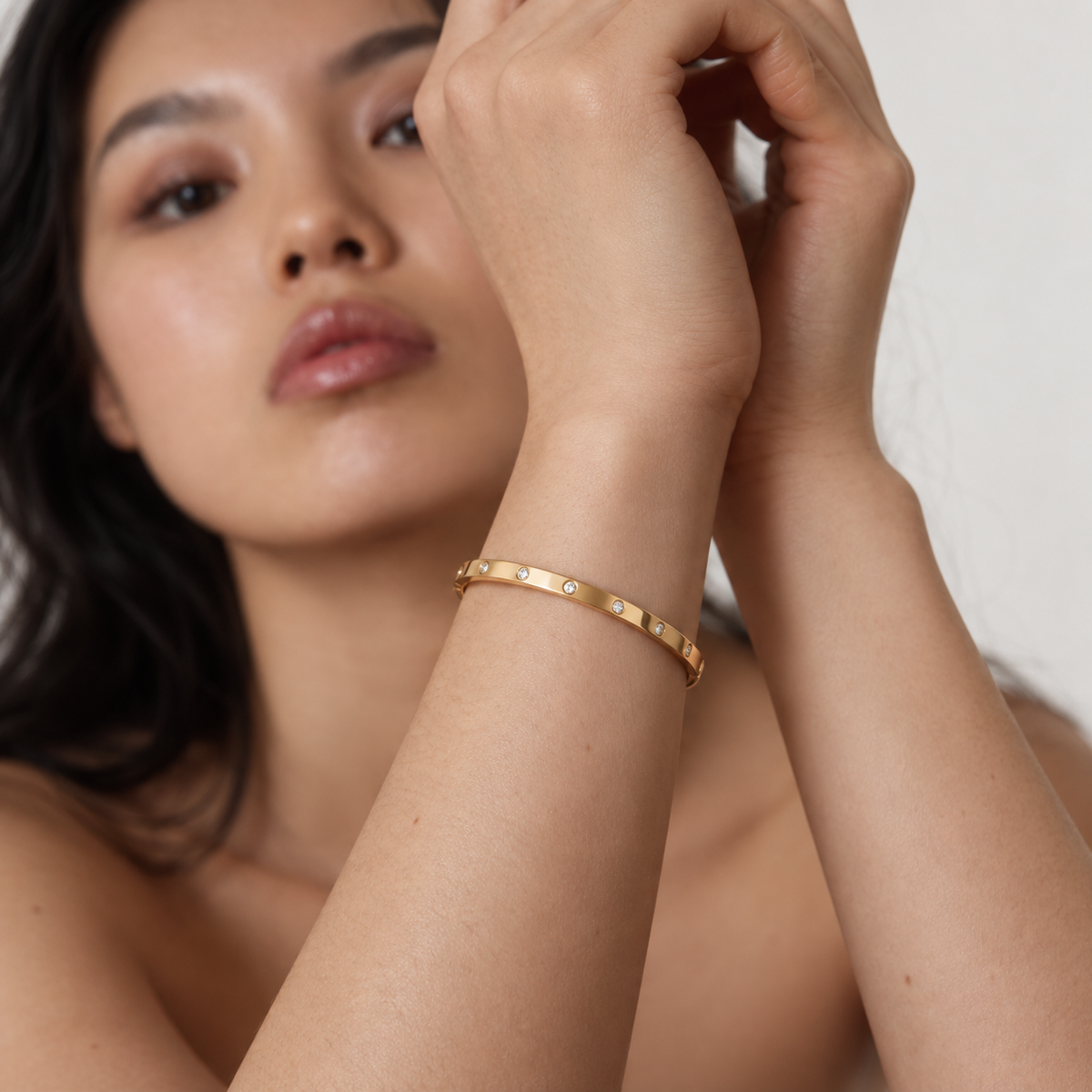 Delphine Zircon Dot Bangle in gold worn by a model — TAIA Jewellery