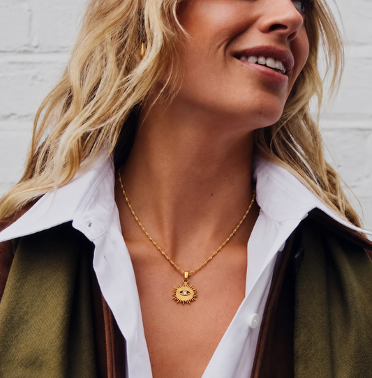 Étoile Eye Necklace with a delicate twisted chain worn by a smiling blonde model