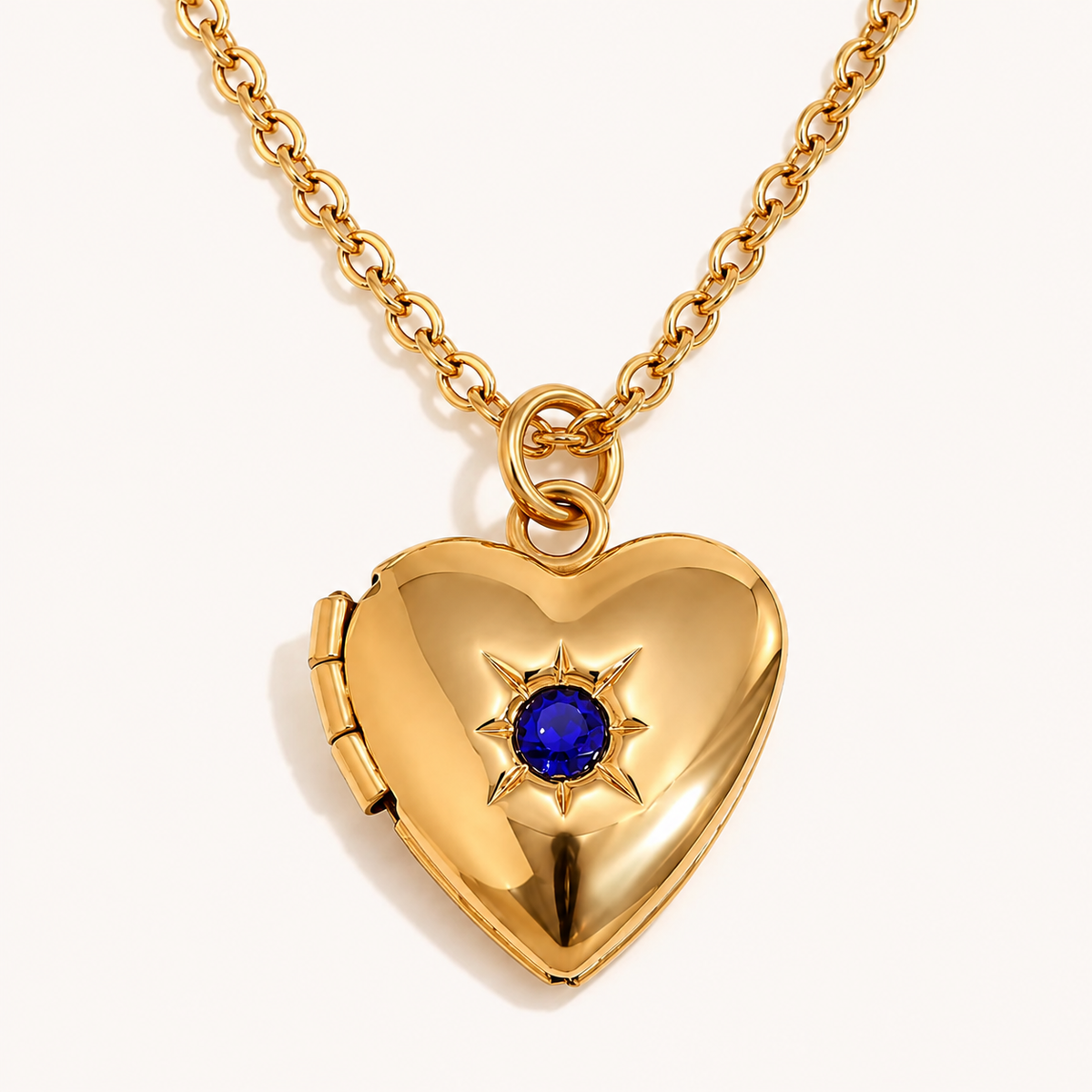Keepsake Heart Birthstone Necklace – gold heart locket with deep blue center stone