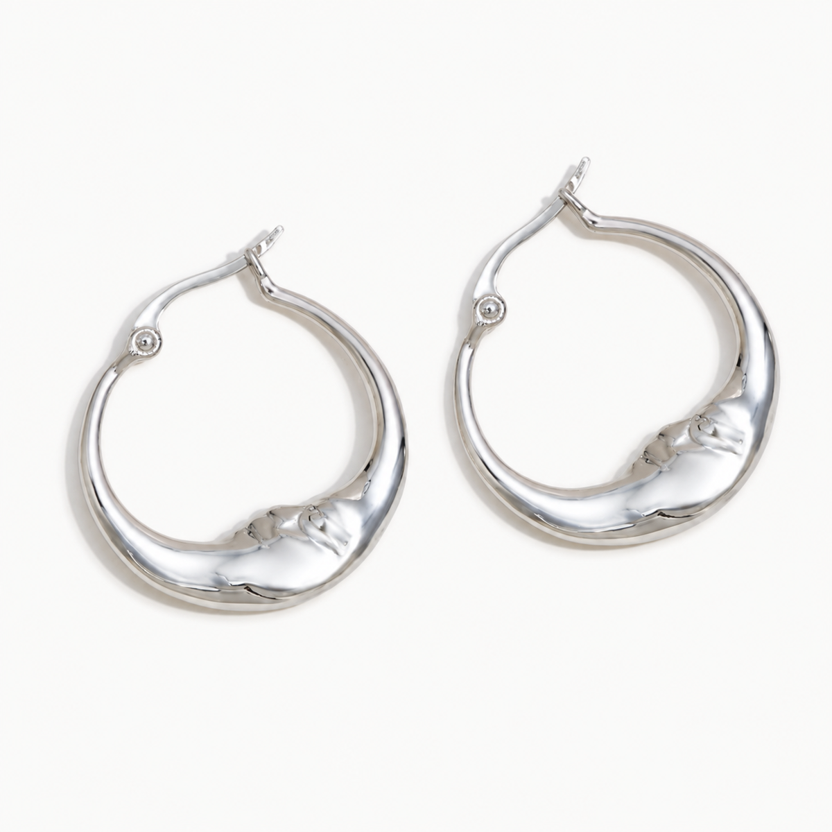 Luna Hoop Earrings – silver crescent hoops with sculpted moon faces
