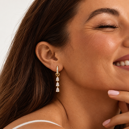 Marielle Triple Drop Earrings in gold worn by a model — TAIA Jewellery