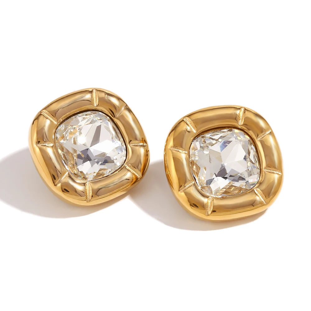 Paloma Cushion Stone Earrings – clear cushion-cut stones in sculptural gold settings on white