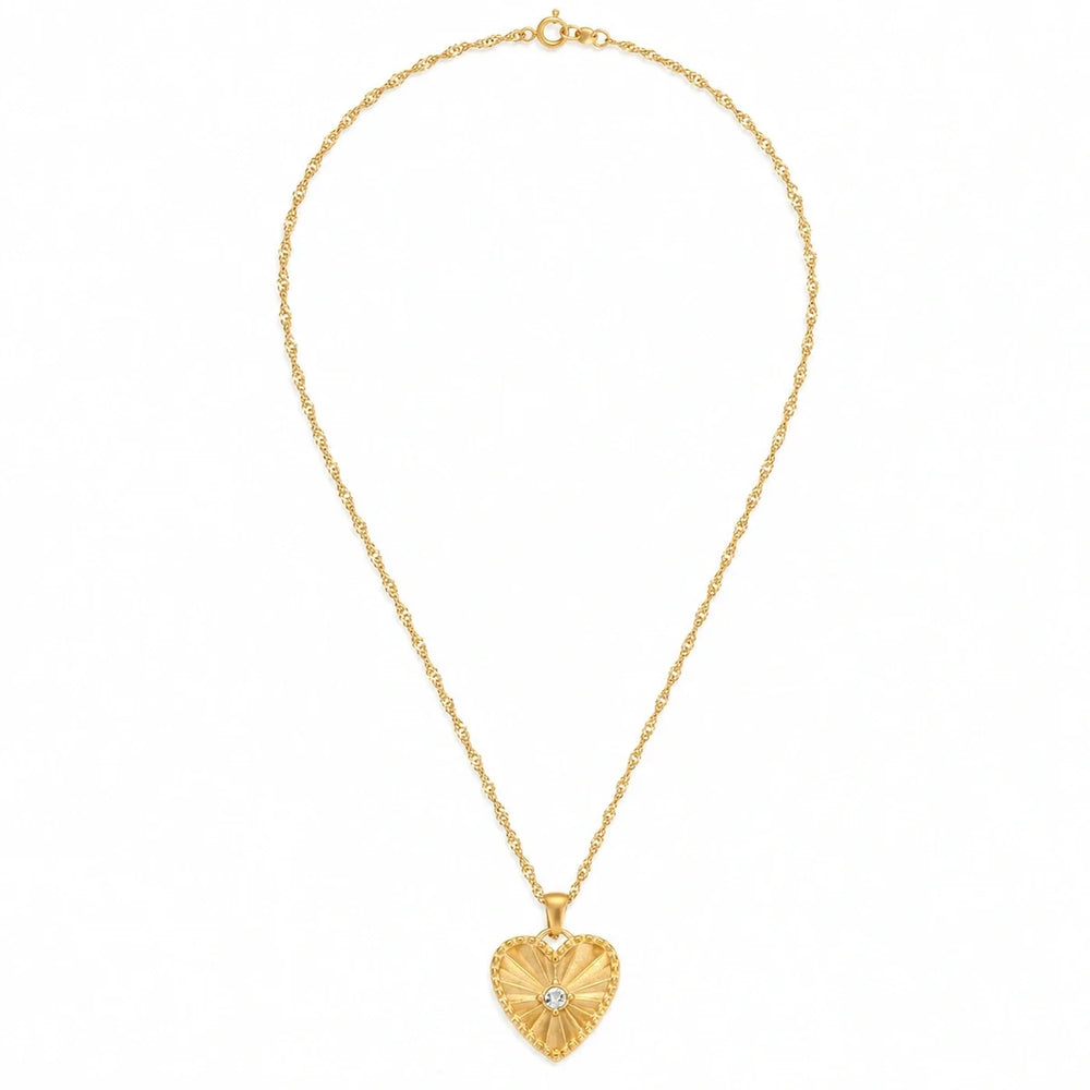 Radiant Heart Necklace – gold heart pendant with radiating lines and clear stone accents on white