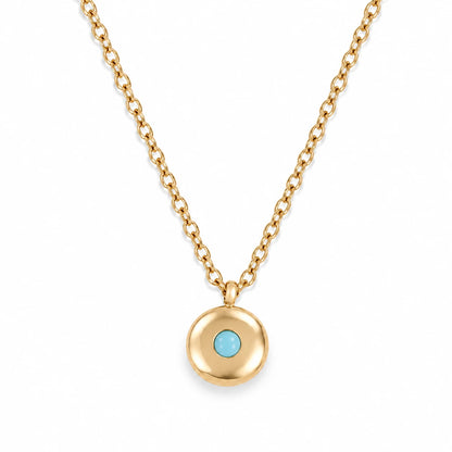 Ruth Birthstone Necklace – December – polished gold birthstone pendant on white