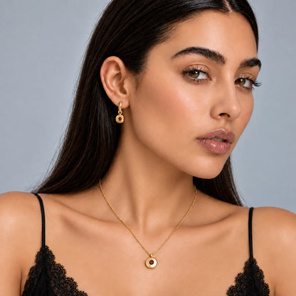 Model wearing Ruth January birthstone necklace with matching red stone earrings