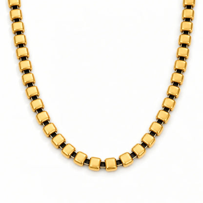 Skye Necklace – polished gold square-link chain shown close-up on white