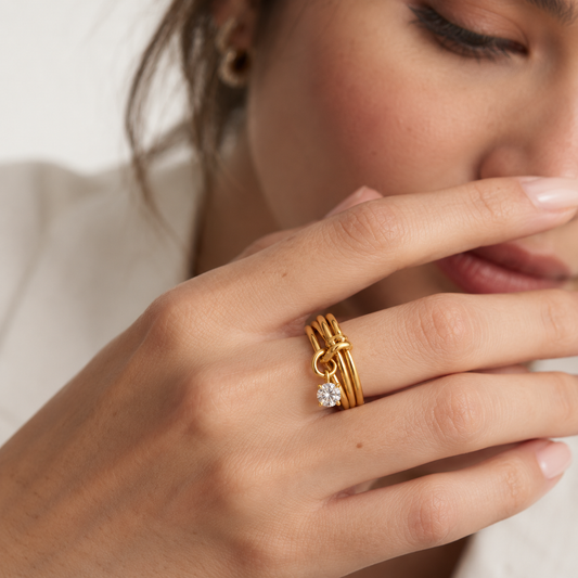 Soline Birthstone Ring in gold with a clear stone worn by a model — TAIA Jewellery