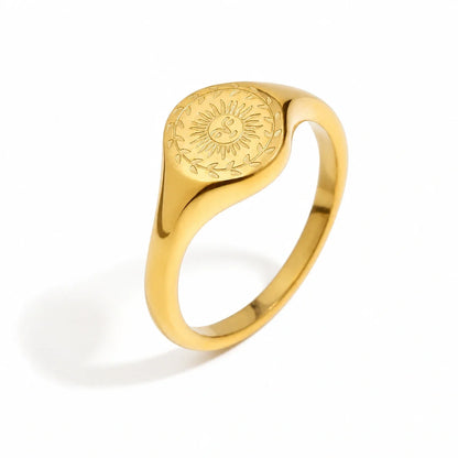Oracle Ring – gold signet ring engraved with a sun face and leafy border on white