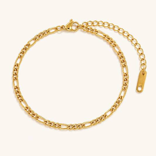 Zuri Figaro Bracelet — 18K gold PVD Figaro chain on a light ivory background